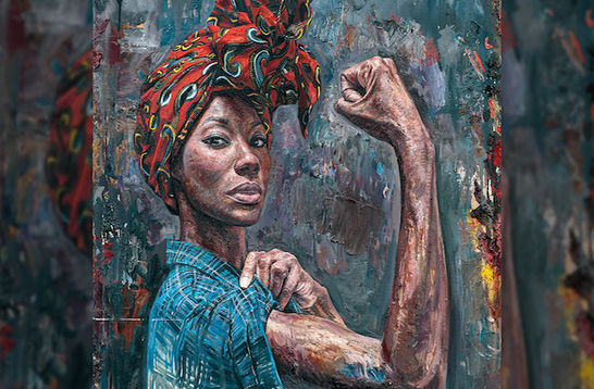 A Black woman with a read and green headwrap and a blue demin shirt is posing in the Rosie the Riveter stance.
