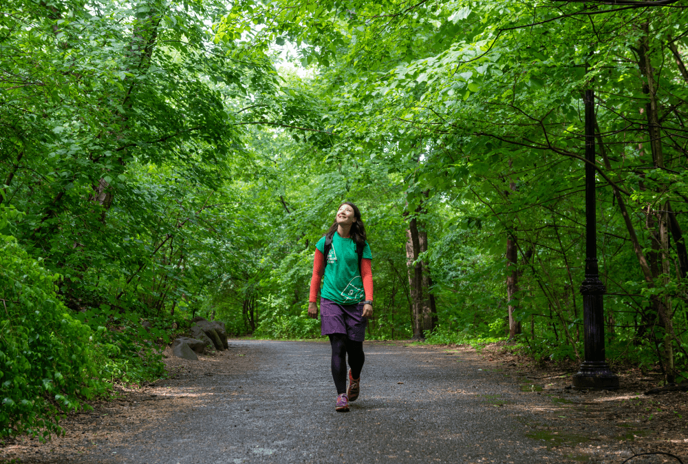 A woman walks in a green park
