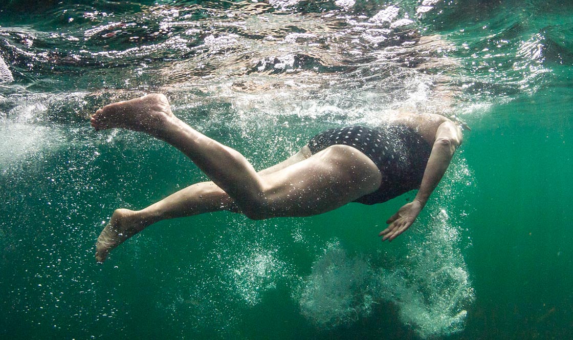 A woman takes an open water swim. Credit: Dan Bolt/underwaterpics.co.uk