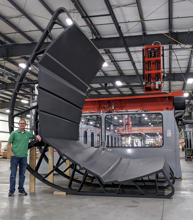 LSAM Program Manager, Scott Vaal with the section of Yacht Mold in front of an LSAM 1020