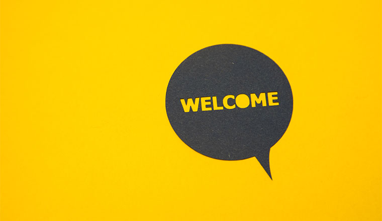 A photo of a speech bubble that says "welcome"
