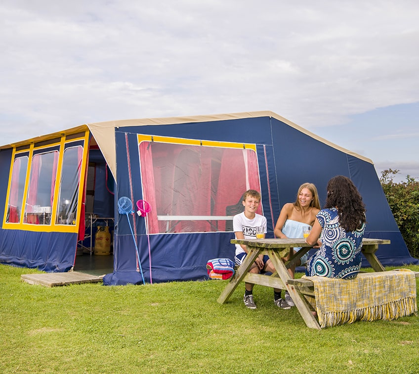 Family sat outside a Ready Tent at Trevornick Holiday Park