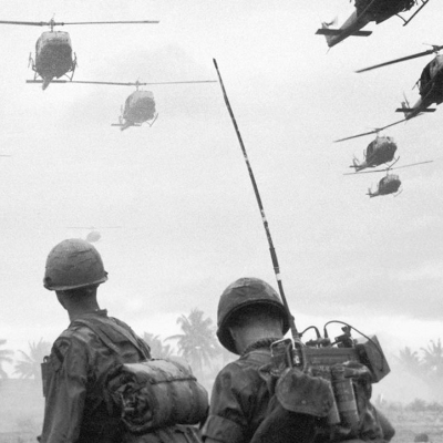 American soldiers watch combat helicopters landing as part of Operation Pershing.
