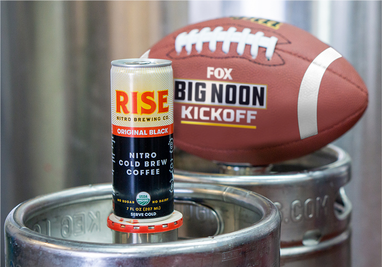 Can of Rise and a college football with the FOX Big Noon Kickoff logo on it.