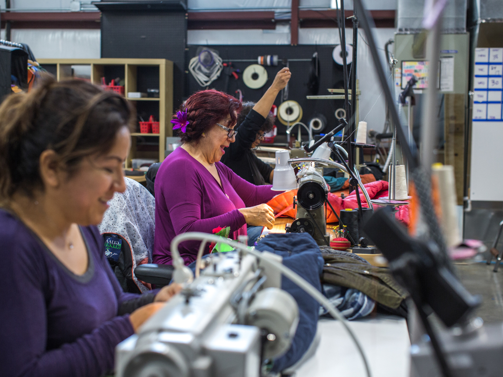 People working in The Renewal Workshop warehouse.