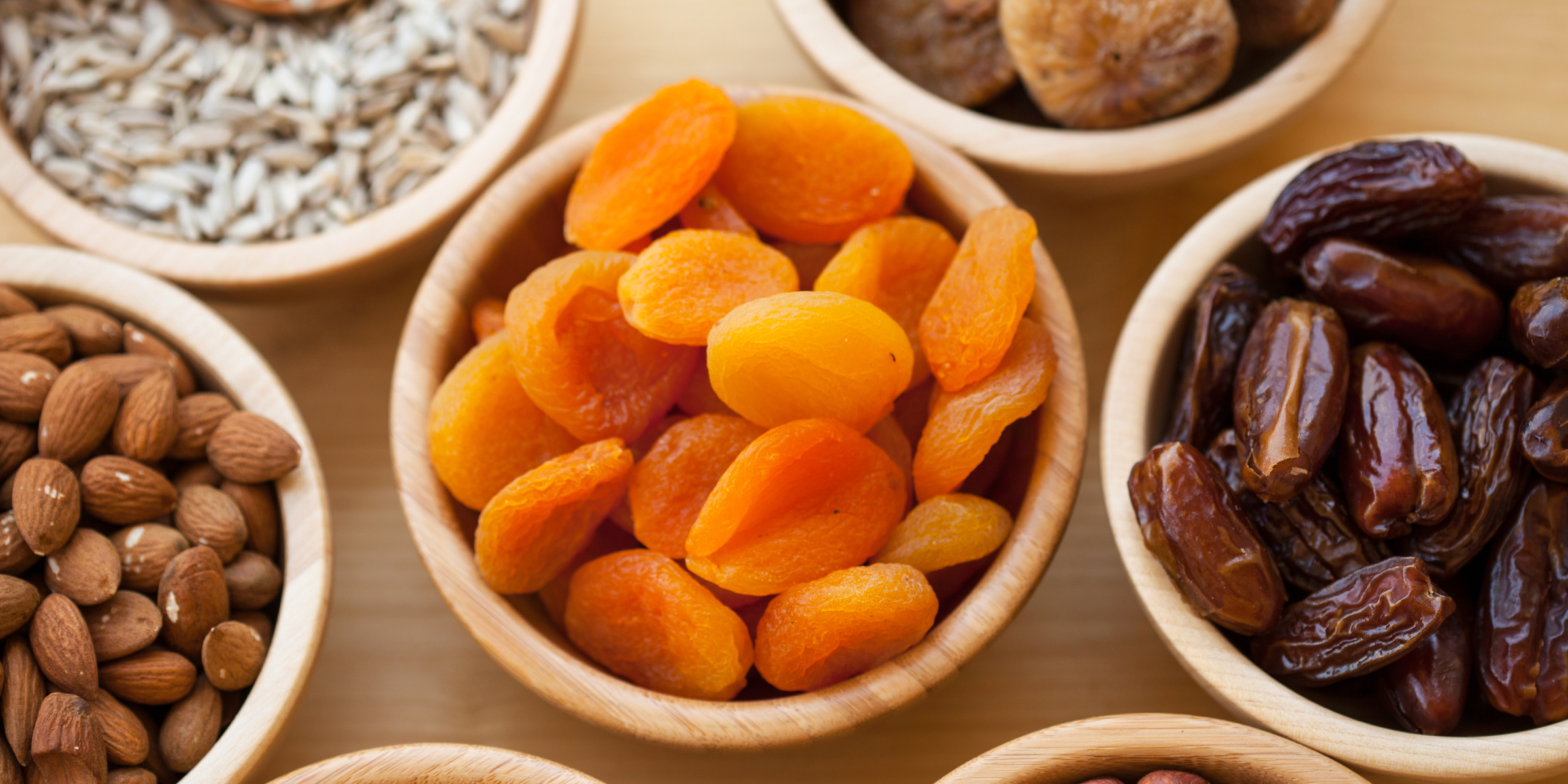 bowls of almonds, apricots and dates