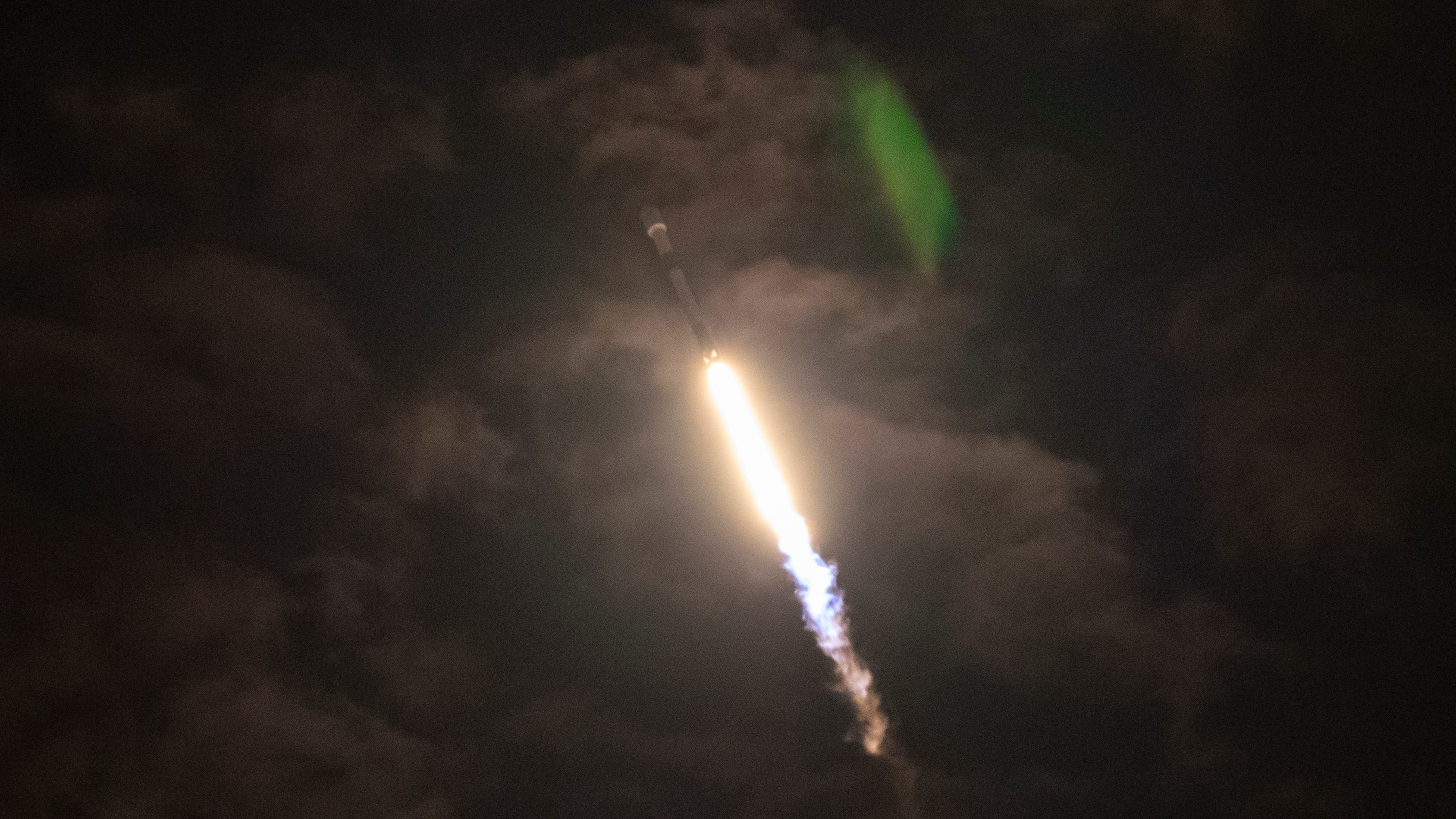 A SpaceX Falcon 9 rocket punches through the cloud
