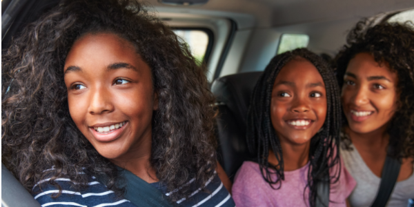 Teen girls riding in a car - Hero image