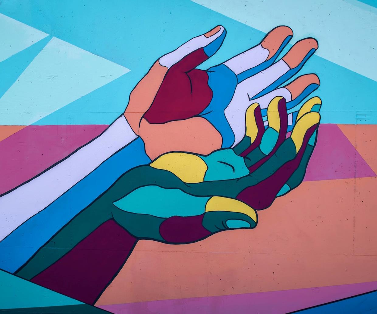 Illustrated colourful hands coming together