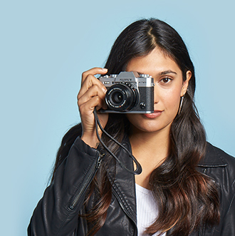 Young woman in leather jacket behind camera