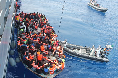 Migrants aboard a rubber vessel are rescued in the Mediterranean. 