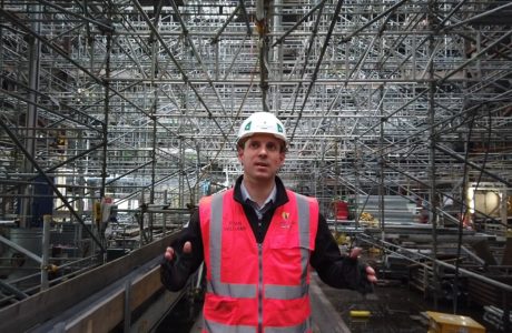 Ryan from Wilmott Dixon standing in Colston Hall surrounded by birdcage scaffolding