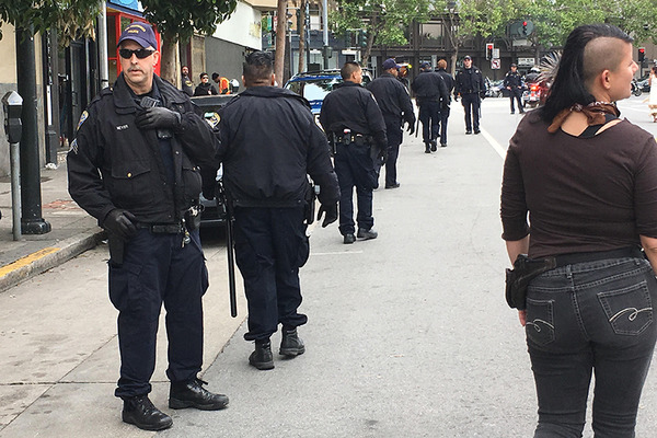 Police accompany protesters from the Mission to City Hall, April 2017. Photo by Laura Waxmann