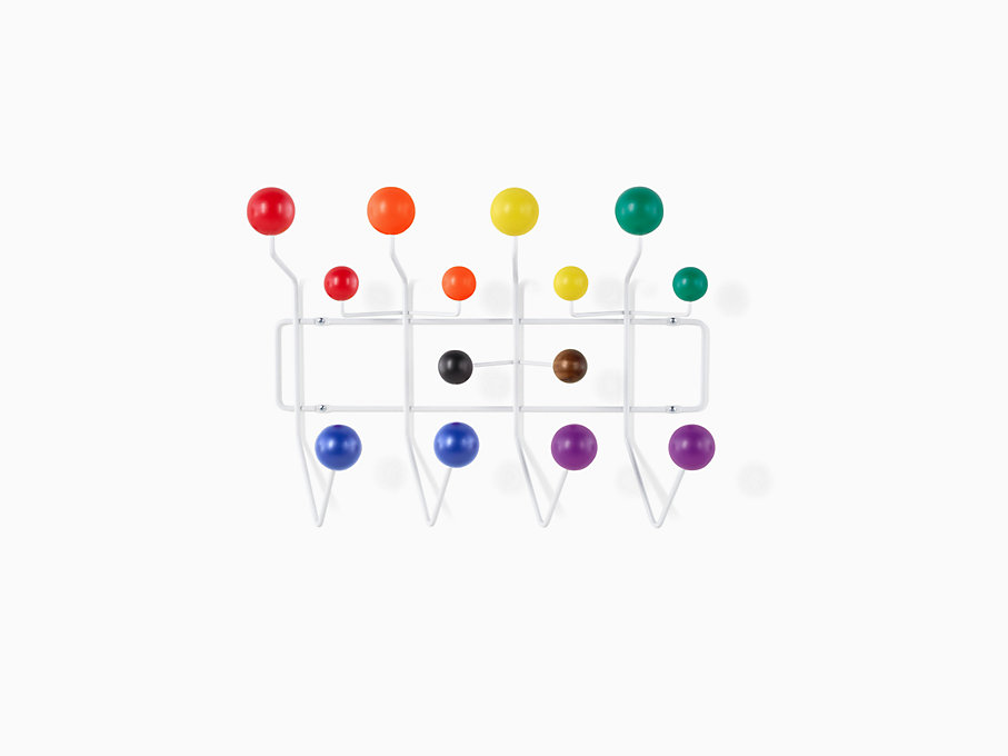 An Eames Hang-It-All with a white frame and balls painted in the colors of the Pride flag
