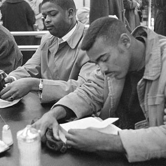 Two men participating in a lunch counter sit-in
