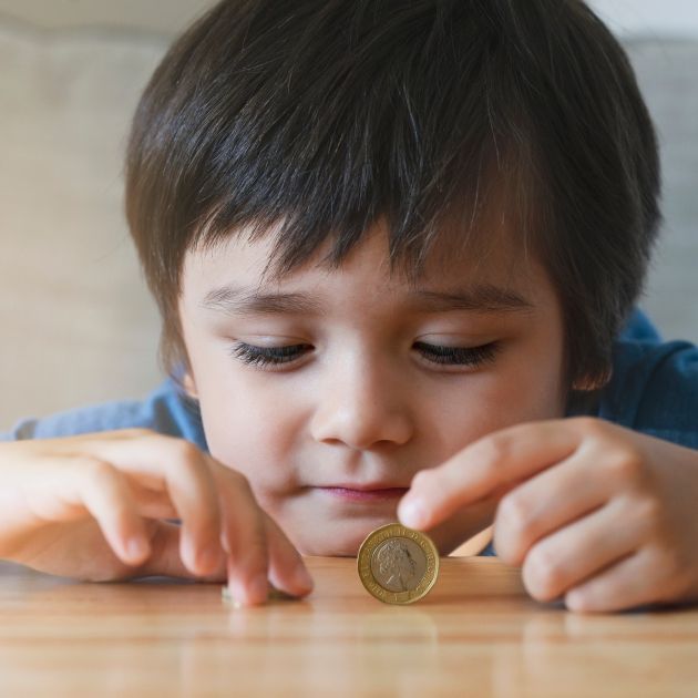 Child playing with a coin