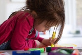 Image of a young girl doing arts and crafts. 