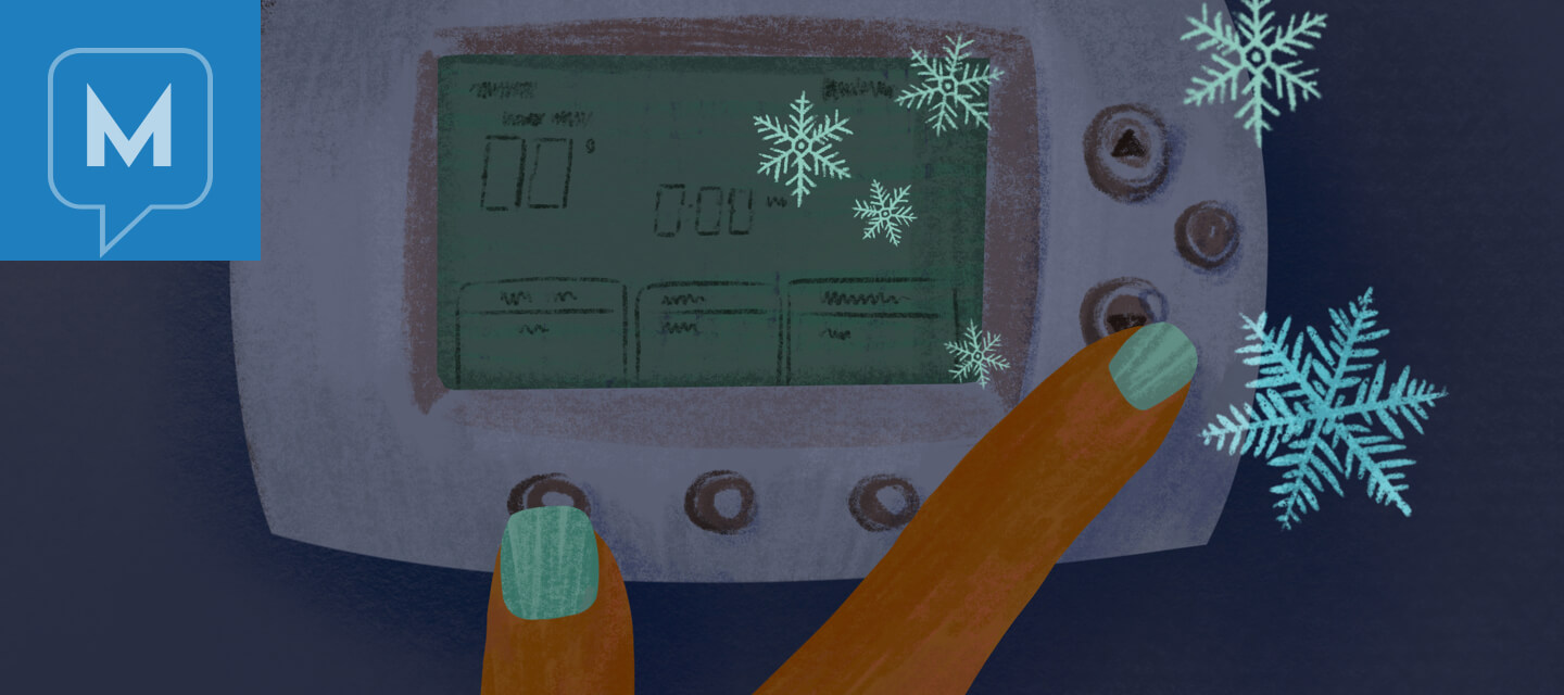 Person adjusts thermostat down to icy cold snowflake temperatures