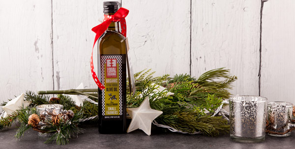 A bottle of Equal Exchange olive oil with holiday decorations