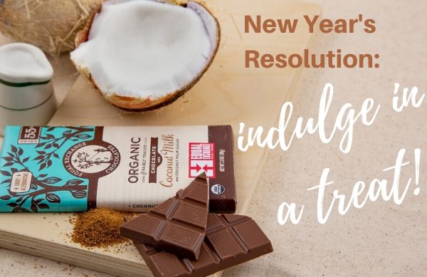 A chocolate bar and a coconut, text reads "New Year's Resolution" Indulge in a treat!"