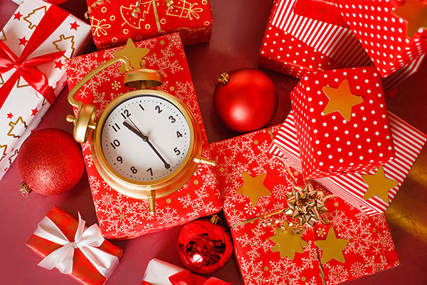 Wrapped gifts with an alarm clock on top