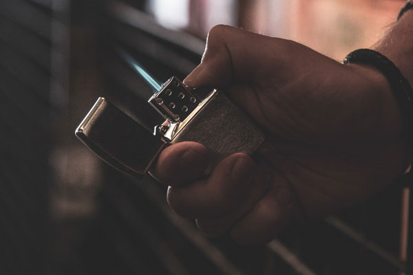 Zippo lighter with single torch insert in hand