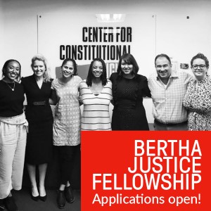 black and white image of seven people smiling back at the camera atop a red rectangle is white text that says bertha justice fellowship applications open