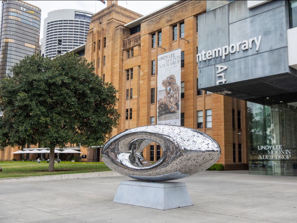 [Lindy Lee''s silver sculpture on the MCA''s forecourt, with MCA building in background]